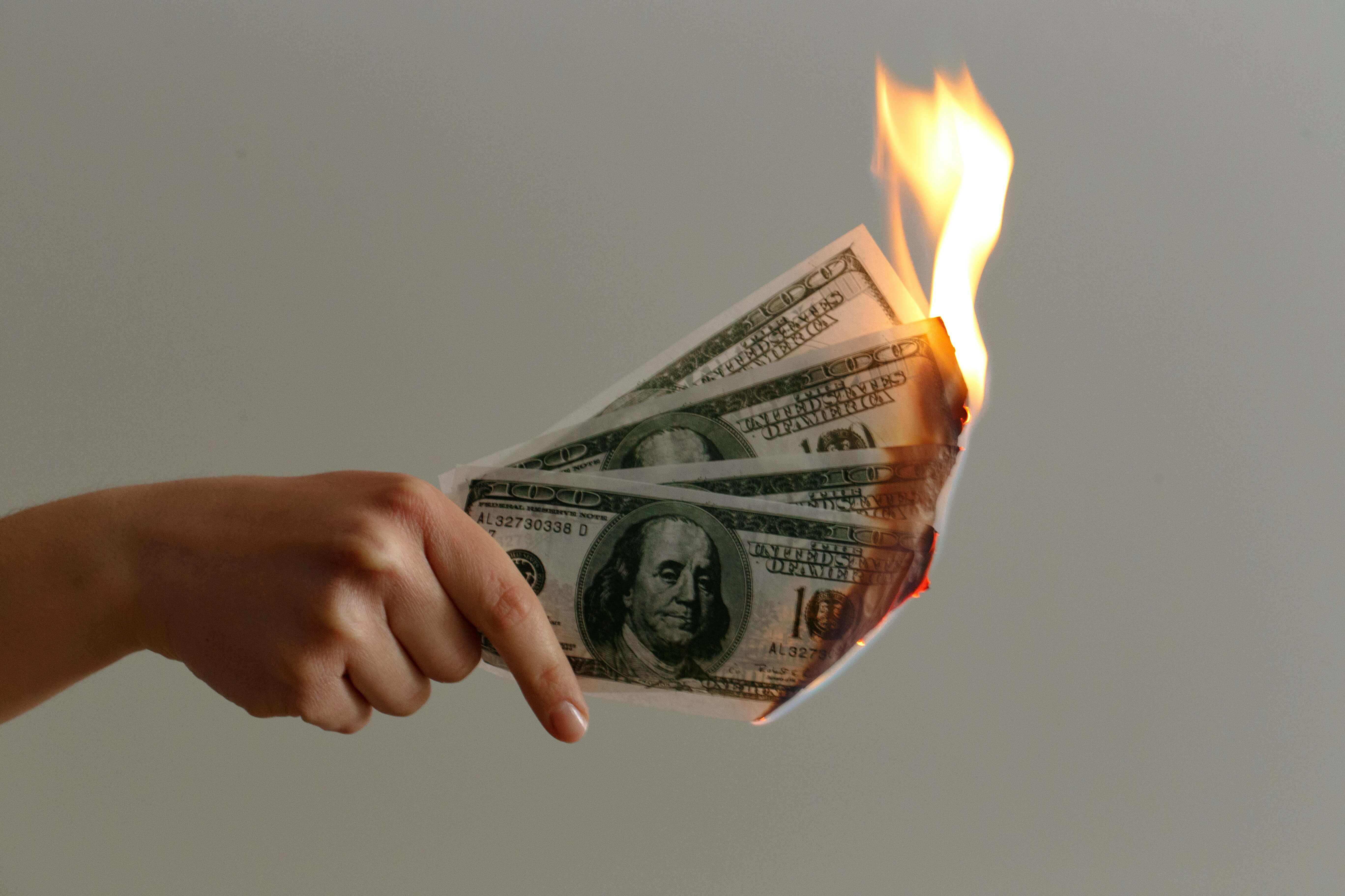 Burning money Photo by Jp Valery on Unsplash