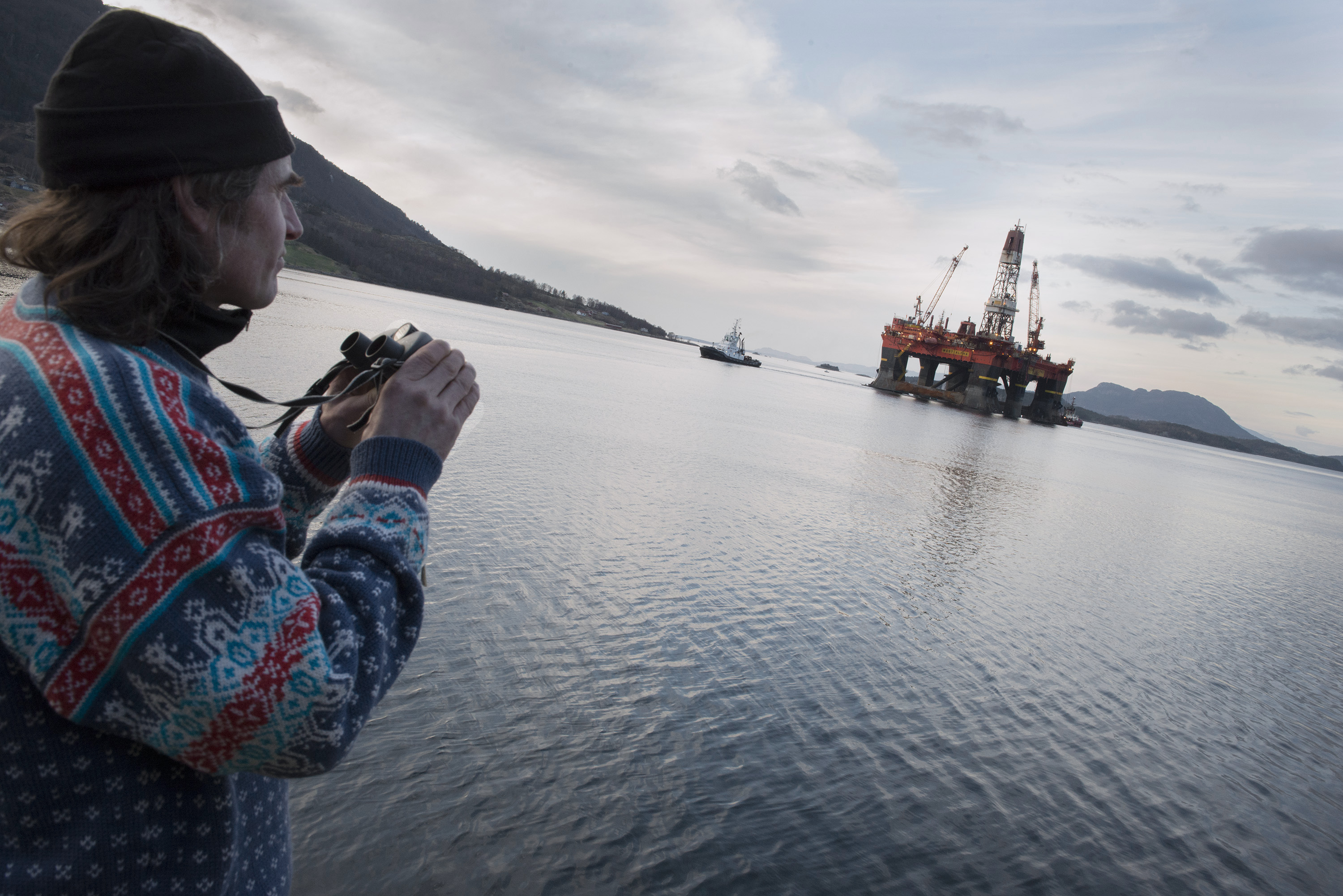 man looking at oil rig